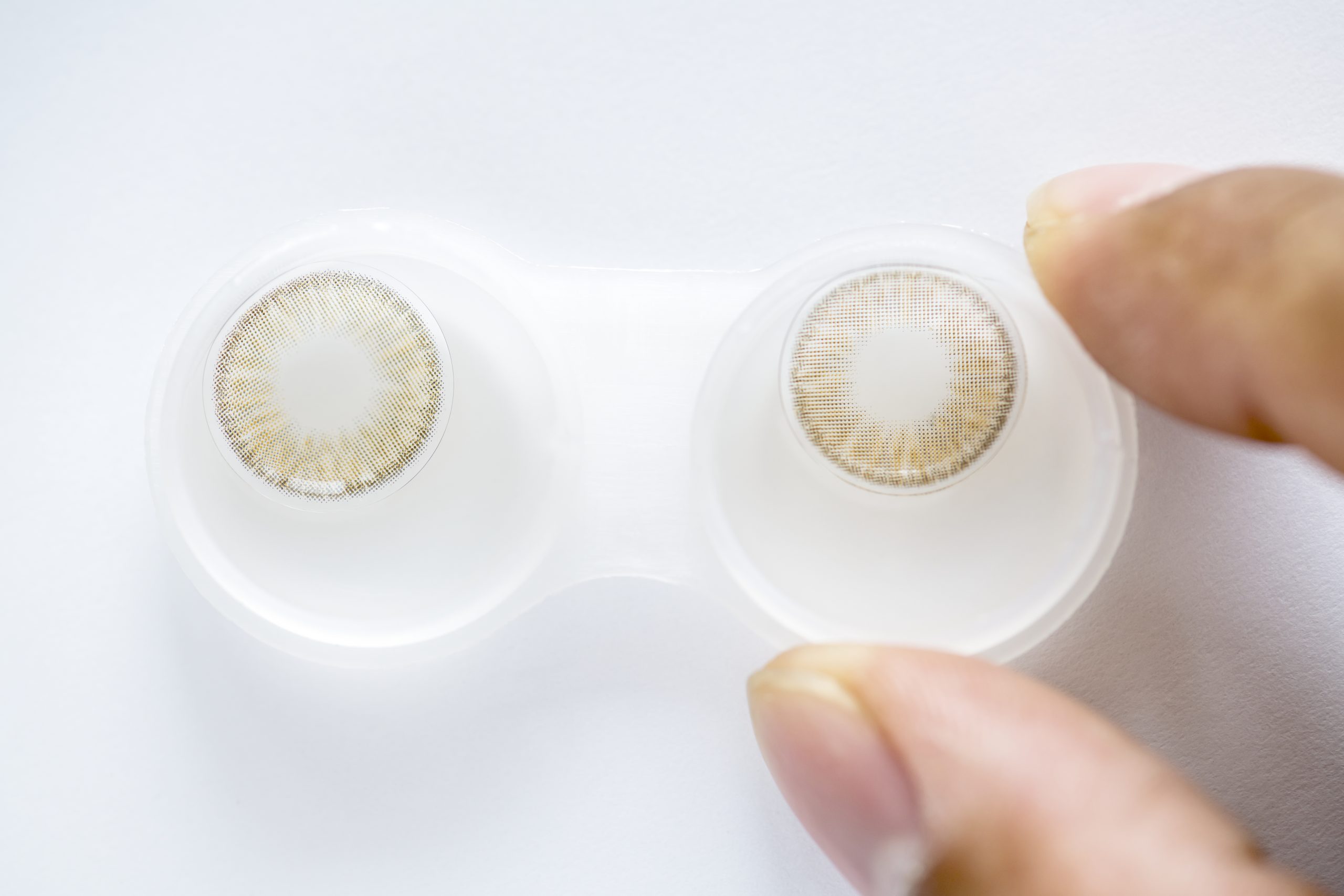 Closeup of colored contact lens in case — UNIQSO